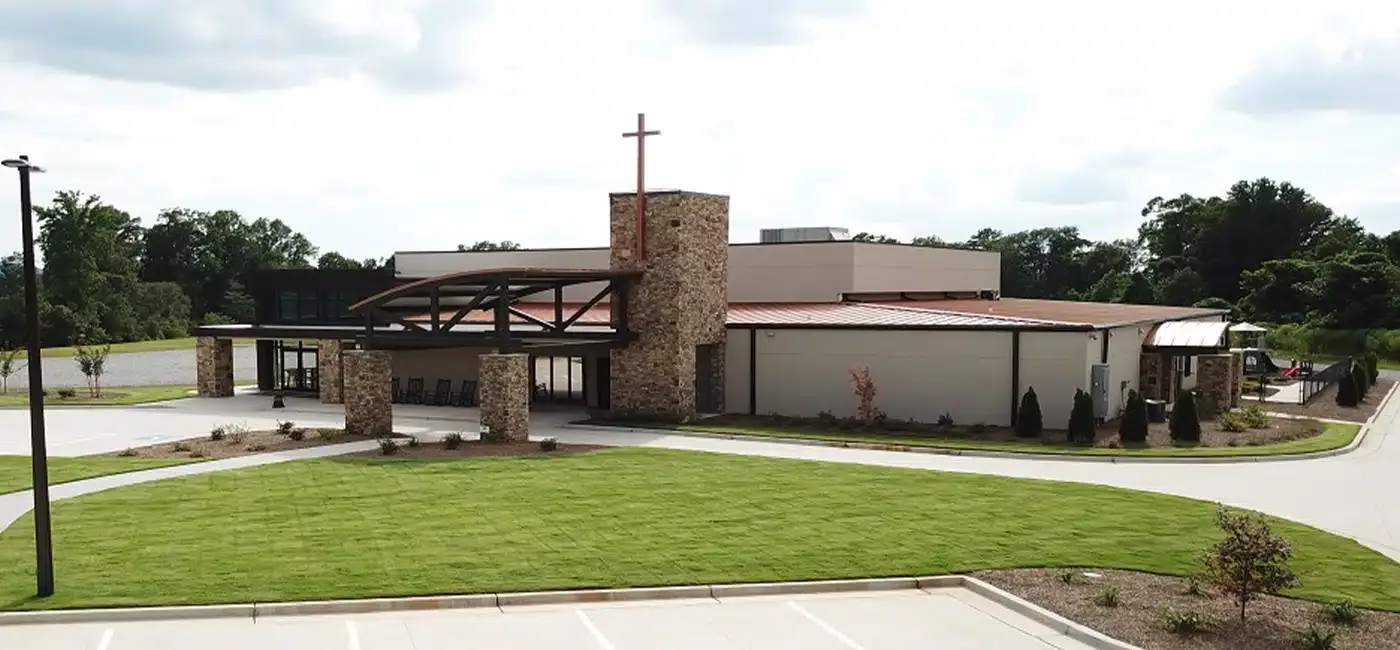 Cleveland Worship Center, a completed Ron Cantrell Construction building with stone columns and a timber entry canopy set on landscaped grounds